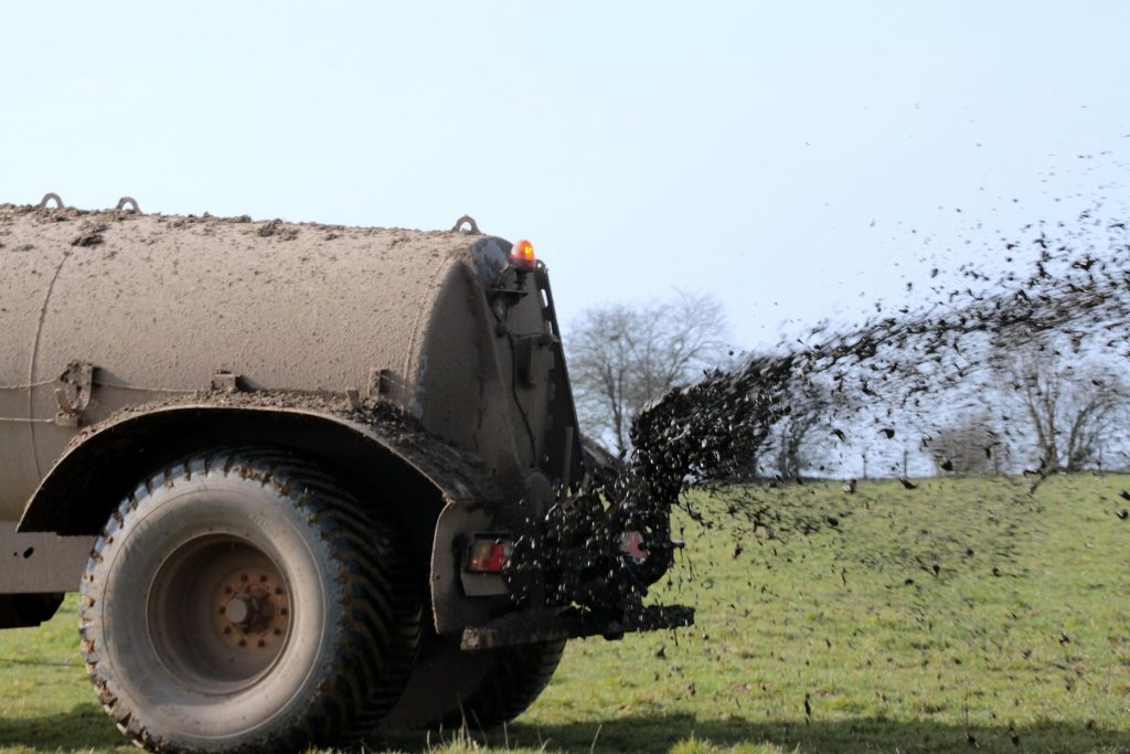 Manure truck fertilizing land - fertilizers responsible for oxygen-poor zones in the oceans.